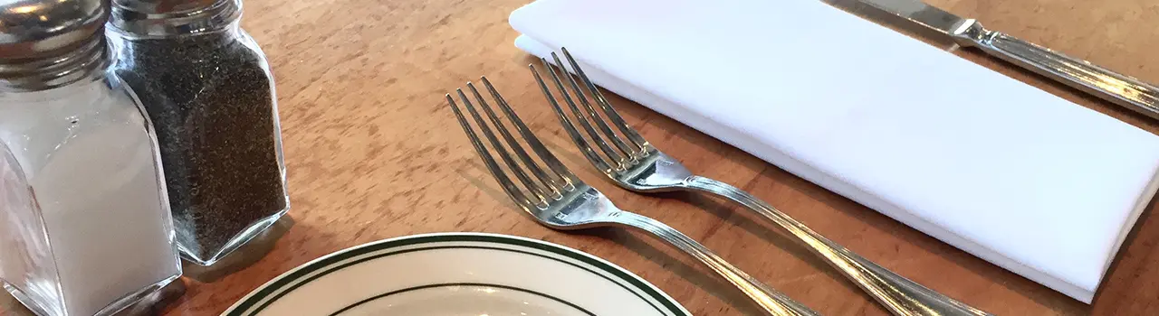 Table setting with utensils and napkin.