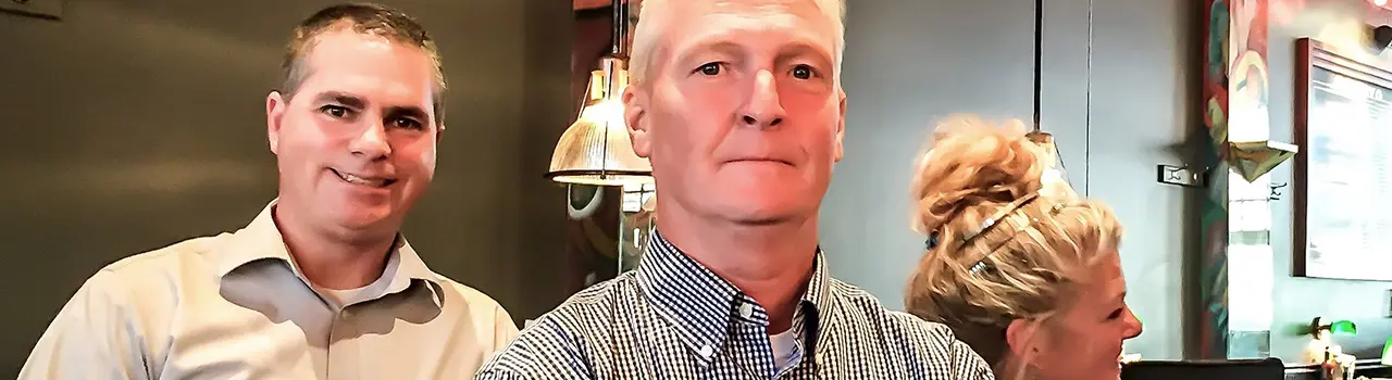 Three people in a casual indoor setting.