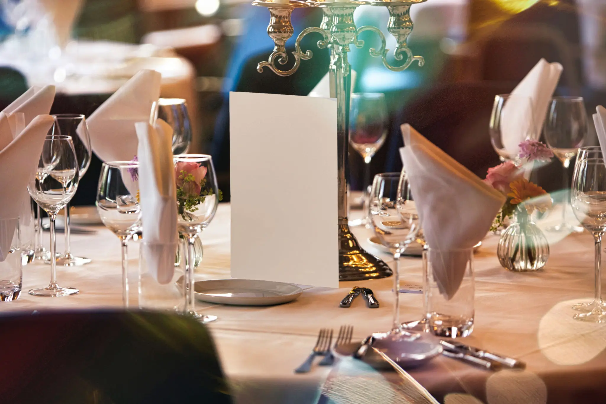 Elegant table setting with candles and neatly folded napkins.