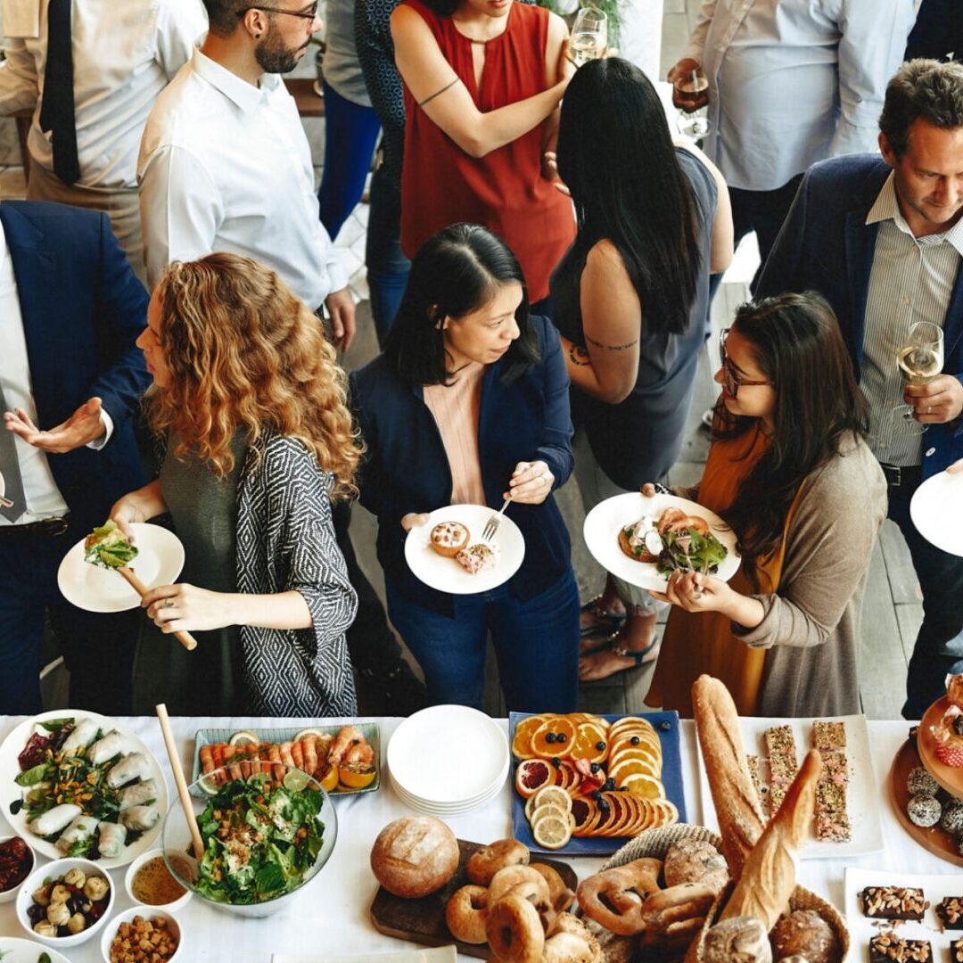 People socializing at a buffet gathering.